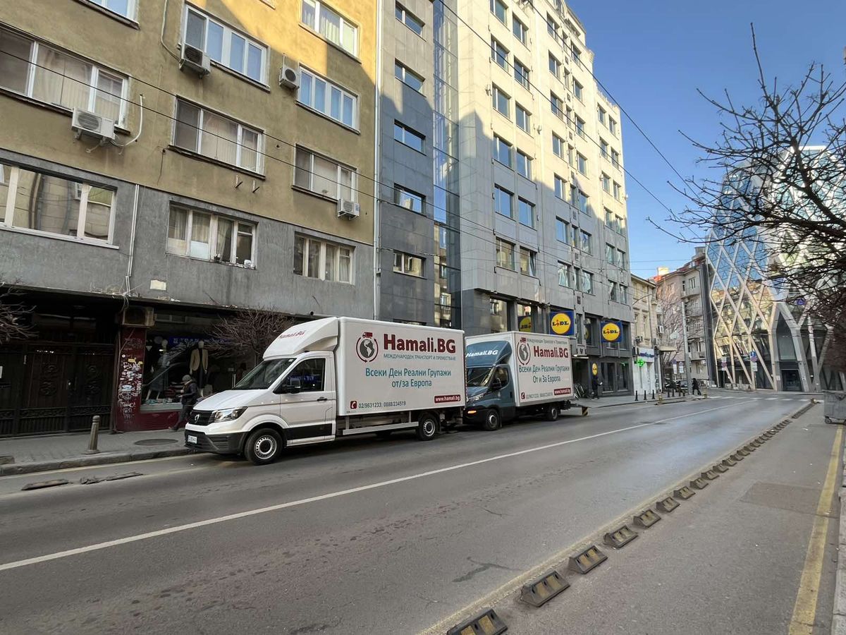 Two Hamali.BG removal trucks parked on a city street
